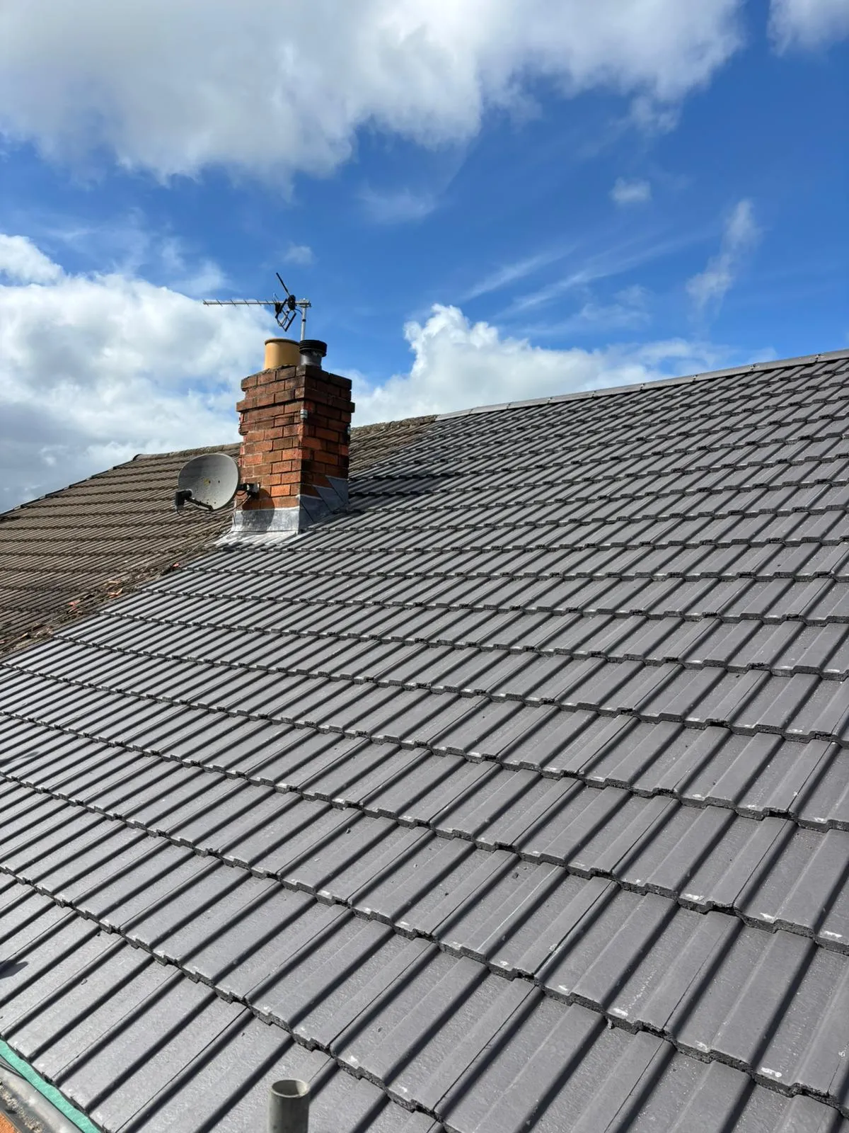 A newly re-tiled roof with chimney by JRD Roofing in Lancashire